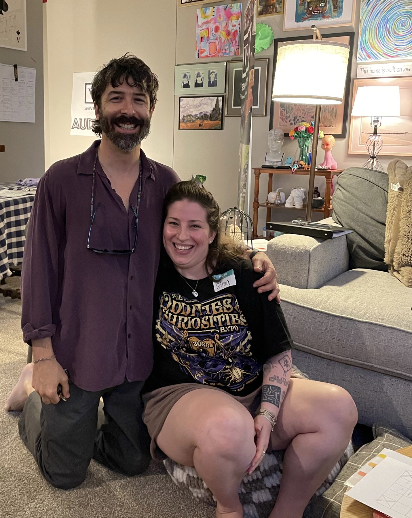 Two ensemble members smile together at a gathering
