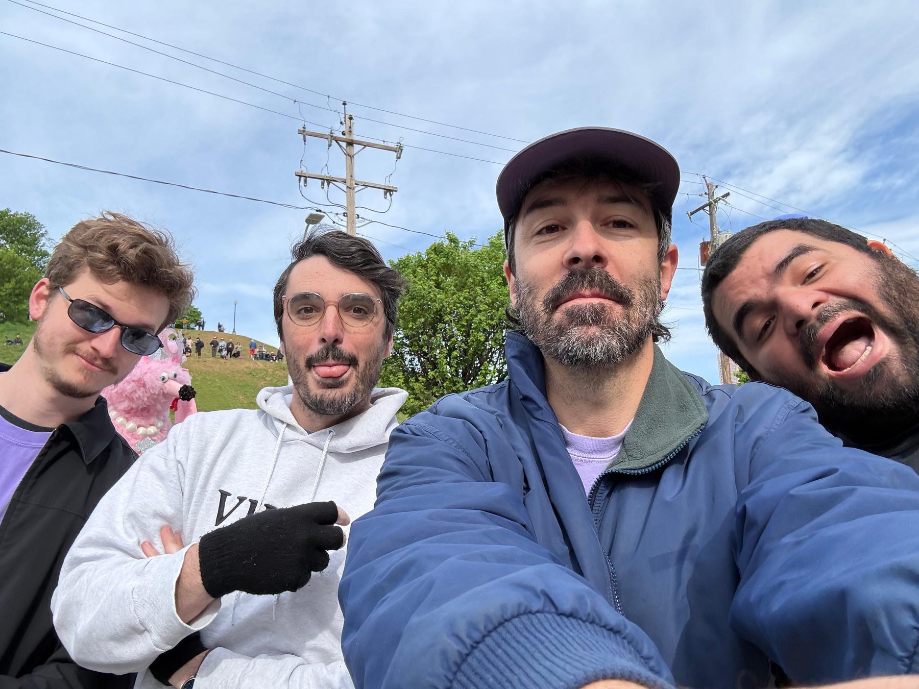 Four ensemble members take a playful outdoor selfie